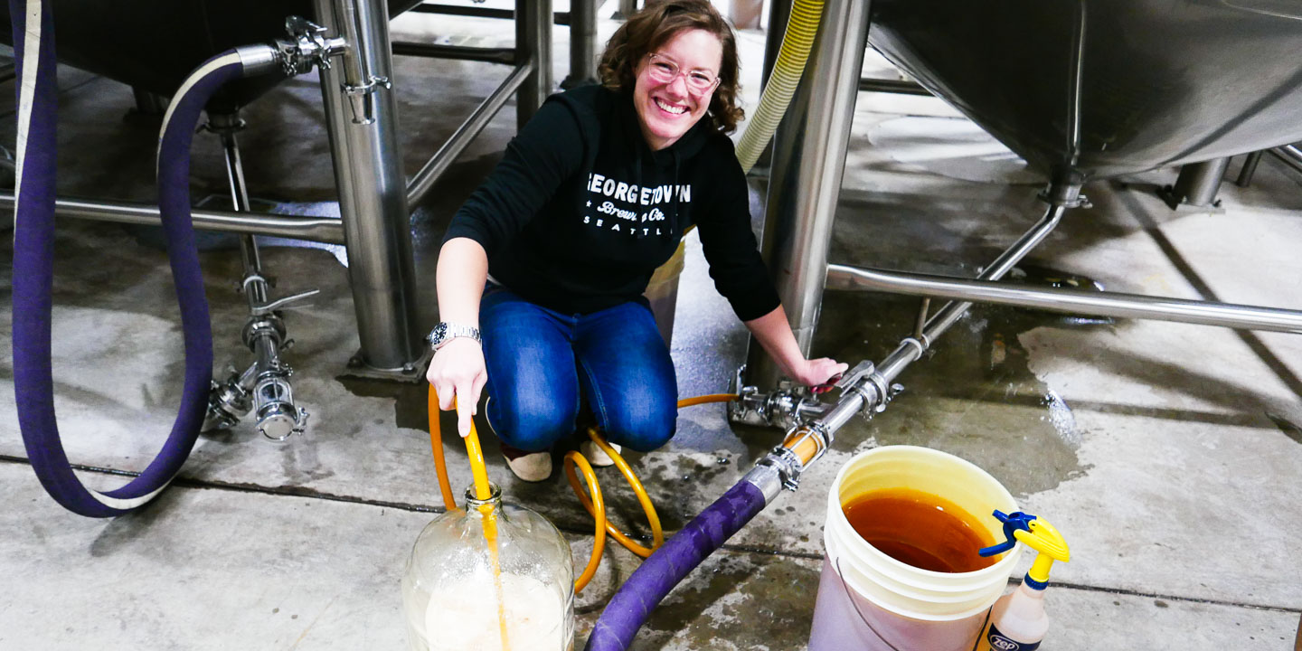 Lab Manager Barb fills a carboy with fresh wort to make a pumpkin saison