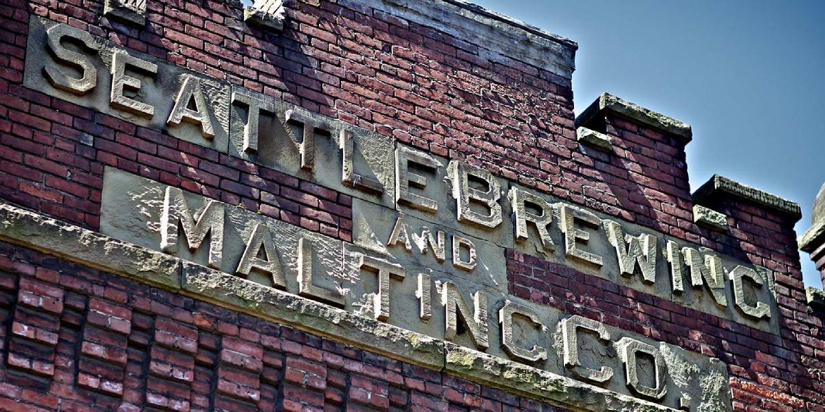 exterior of original Rainier Brewery and the Seattle Brewing and Malting Co sign in stone