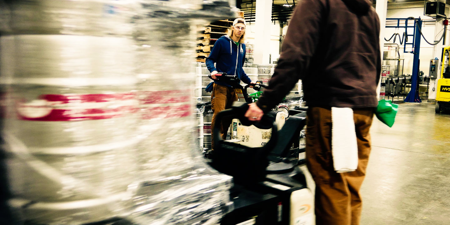 Brewer Craig transports kegs on an electric pallet jack